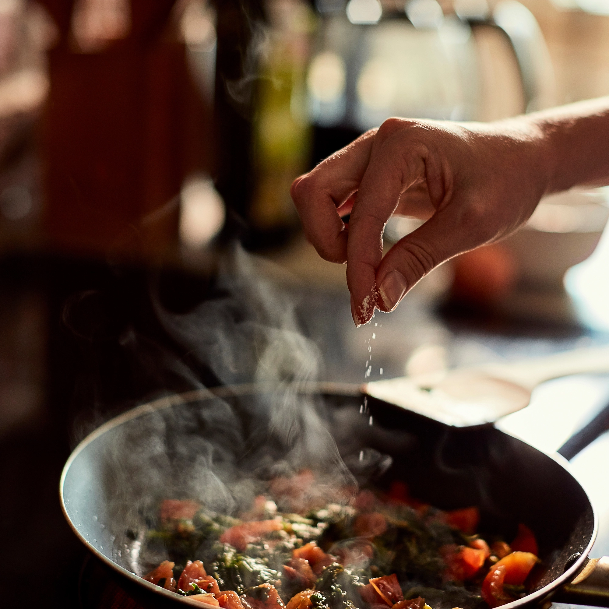 Marla seasoning a healthy dish with all purpose seasoning